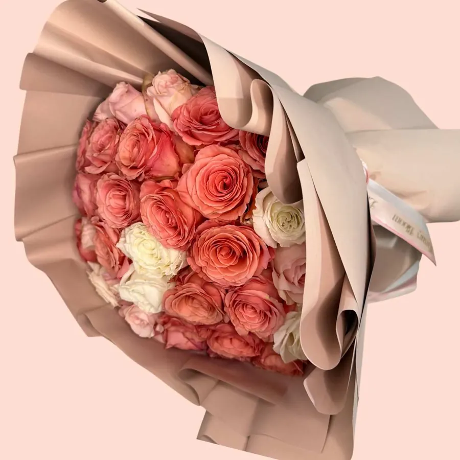 Coral Chic Bouquet - Standard - 48-50 roses Deluxe - 73-75 roses Premium- 99-100 roses A sophisticated arrangement featuring roses in coral, ivory, and soft blush tones. Each bloom is carefully selected to create a harmonious design that evokes sweetness, romance, and elegance. Perfect for special moments or simply to say “you’re on my mind.